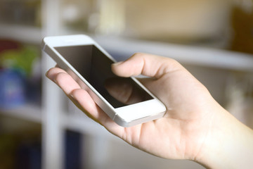 Woman holding smartphone indoors