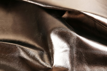 Dark brown shiny leather texture close up