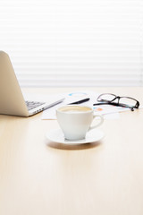 Office workplace with with laptop and coffee