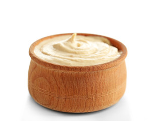 Wooden bowl of tasty hummus, isolated on white
