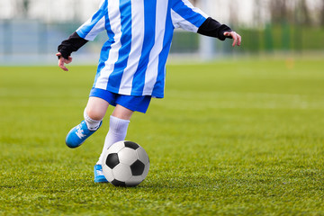 Child Young Boys Kicking Soccer Ball. Kid Playing Soccer.