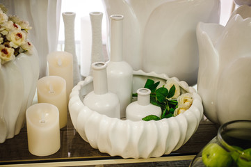 Fototapeta na wymiar white unglazed ceramic vases with candles decor