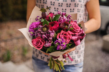 purple flower bouquet composition  in hands