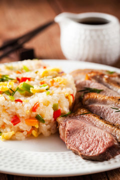 Fried duck  and rice with vegetables and eggs