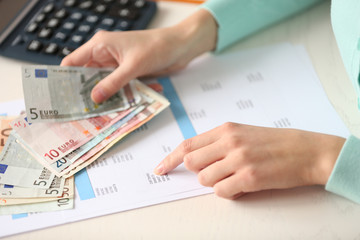 Woman counting money at the table