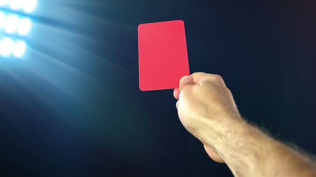 Soccer penalty red cards on black background, slow motion