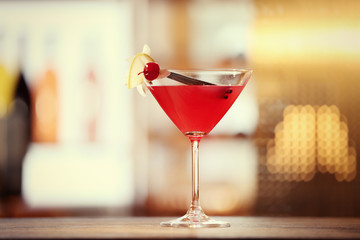 Glass of cocktail on bar background