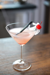 Glass of cocktail on bar background