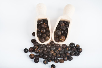 Wooden scoop with dried juniper berries