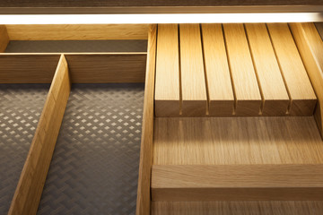 Closeup of open wooden drawer for cutlery