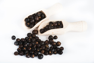 Wooden scoop with dried juniper berries