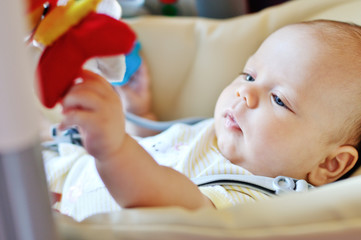 baby laying in bouncer chair