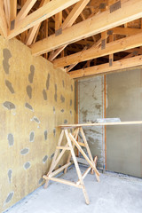 House under construction. Facade layers over  insulation, mesh,plaster, cement, mortar