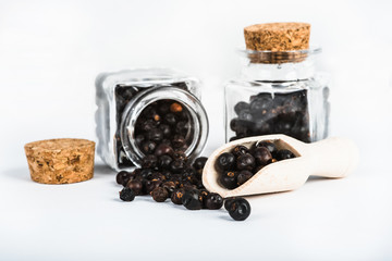 Wooden scoop with dried juniper berries