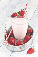 Strawberry milkshake and strawberries.
