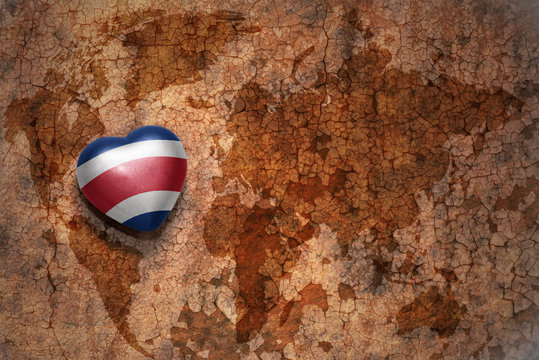 heart with national flag of costa rica on a vintage world map crack paper background. concept