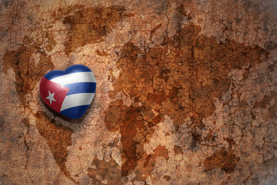 heart with national flag of cuba on a vintage world map crack paper background. concept