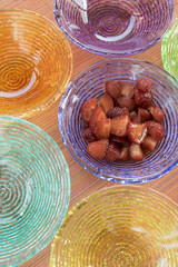 strawberries macedoine in colored bowls