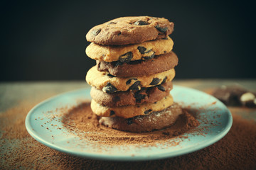 Chocolate chip cookies on plate on wooden table