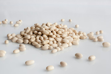 White beans scattered on white background