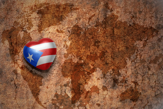 heart with national flag of puerto rico on a vintage world map crack paper background. concept