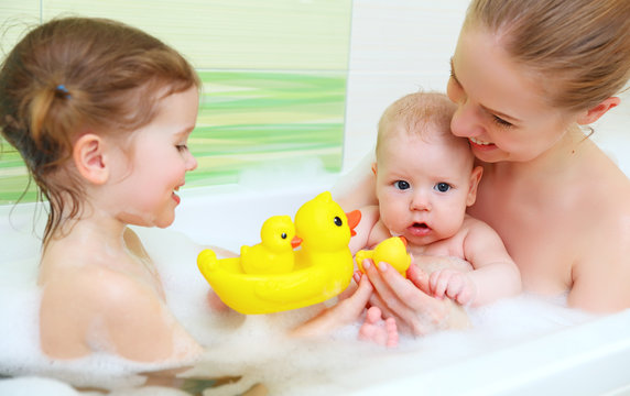 bathing in  bath with foam mother together children baby