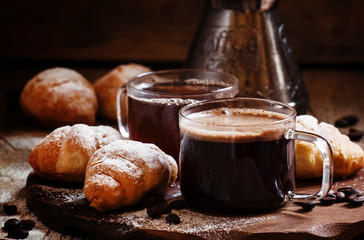 Espresso coffee in a glass cup with small croissants, coffee mak