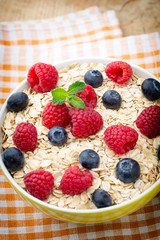Oatmeal porridge with berries. Raspberries and blueberries.