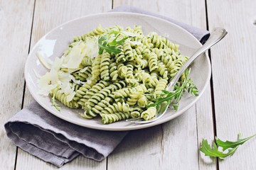 Pasta with pesto ,arugula and parmesan.Selective focus