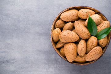 Group of almond nuts with leaves.Wooden background.
