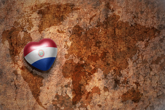 heart with national flag of paraguay on a vintage world map crack paper background. concept