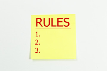 rules word written on yellow sticky notes. 