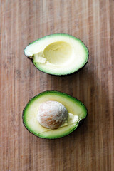 Fresh Avocado Sliced in Half on a board