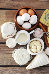 Set of fresh dairy products on old  wooden table, close up