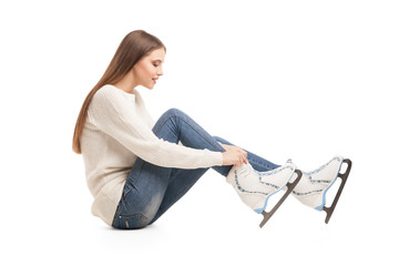 young woman in pair of ice skates isolated
