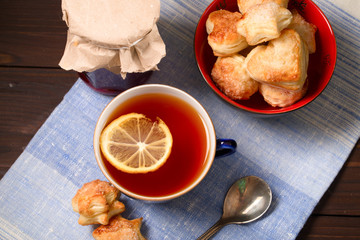 Cup of tea, home-made cookies and jar of jam