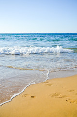 Fototapeta na wymiar Footprints in the sand. Beach in Malia (Greece, Crete)