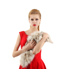 Fototapeta na wymiar Young beautiful blonde girl wearing perfect makeup and red dress posing in a fur over white studio background