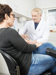 Doctor Collecting Patient's Blood For Test In Hospital