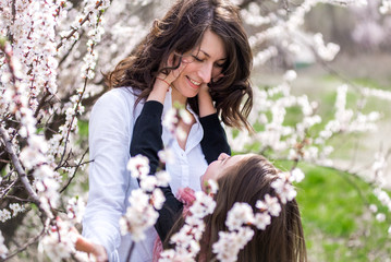 Mother and daughter walking in the garden