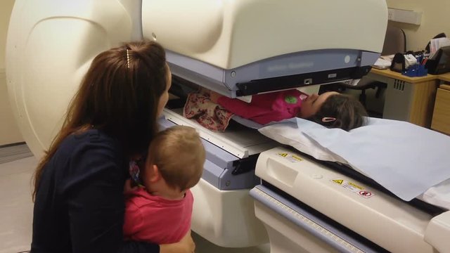 Child Having A Kidney Scan In Hospital With A Specialized Machine