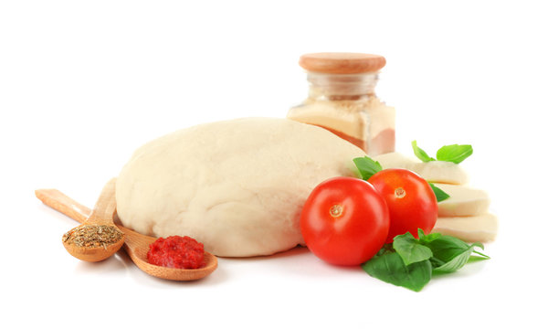 Fresh dough and other ingredients for pizza isolated on white