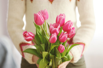 Bouquet of pink tulips in hands of beautiful young  girl, close up