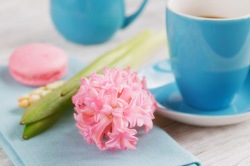 Cup of black coffee and pink flower