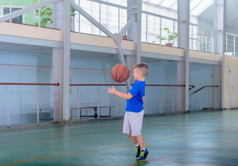 Young boy playing basketball on an indoor court