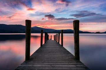 Tuinposter Stunning vibrant pink and purple sunset on a beautiful evening at Ashness Jetty, Derwentwater, Lake District, UK. © _Danoz