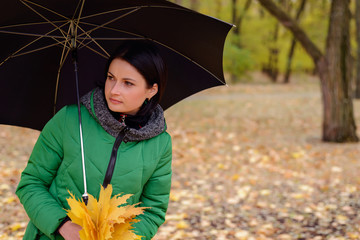 Curious woman with leaves and umbrella