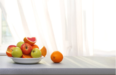 Plate of ripe fruits on a table
