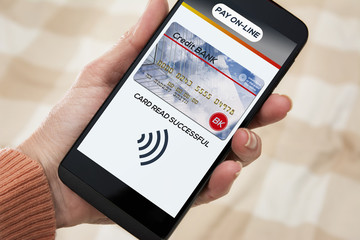 Woman paying by credit card, via mobile app.