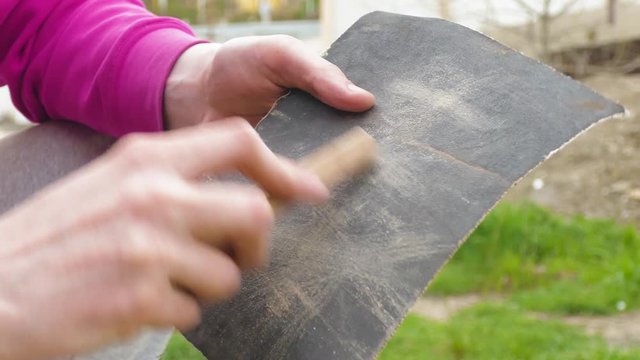 grinding of wooden plank using glass-paper
